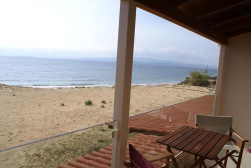 a view of the beach from the porch of a house at Ammos Residence in Minia