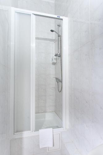 a shower with a glass door in a bathroom at VitaPark Borysfen in Kyiv