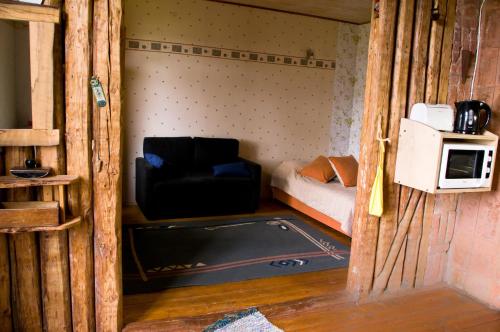 a small room with a bunk bed and a microwave at Salme Apartment in Tartu