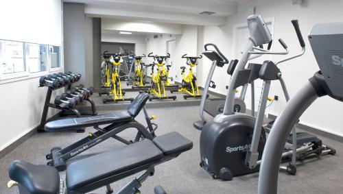 a gym with several treadmills and cardio machines at Sallés Hotel Pere IV in Barcelona