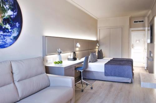 a hotel room with a bed and a couch at Sallés Hotel Pere IV in Barcelona