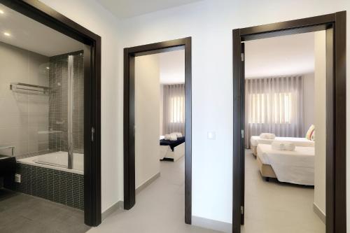 a bathroom with a glass door leading to a bedroom at Original 3 Bedroom Downtown in Albufeira
