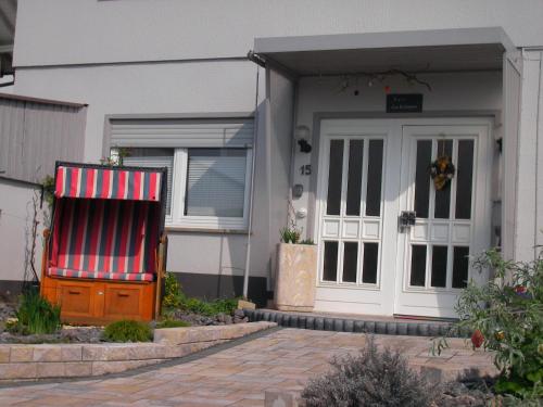 a house with a red and white awning next to a door at Haus Ellbogen in Momlingen