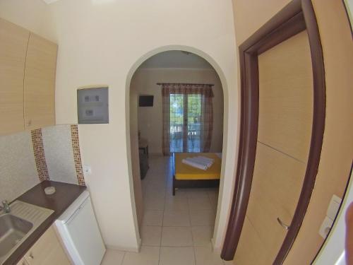 a kitchen with an archway leading to a bedroom at Pouliezos Koklanis Zante Apartments in Alykes
