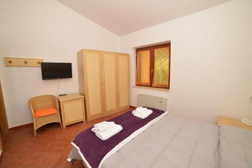 a bedroom with a bed with two towels on it at La Locanda di Campagna in Agropoli