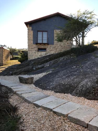 a stone path in front of a stone house at Quinta do Medronheiro Hotel Rural in Viseu