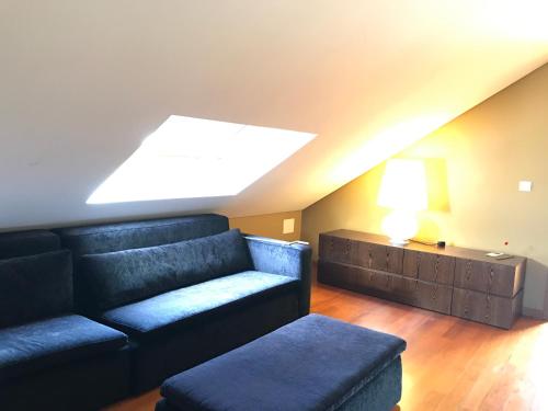 a living room with a couch and a table at Quinta do Medronheiro Hotel Rural in Viseu