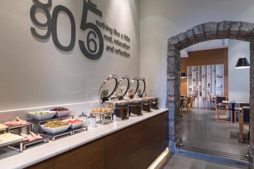 a buffet line with food on display in a restaurant at Aegli Hotel Volos in Volos