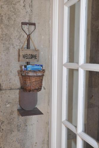 a basket with a welcome sign next to a window at 16 Porto Santo Apartments in Porto Santo