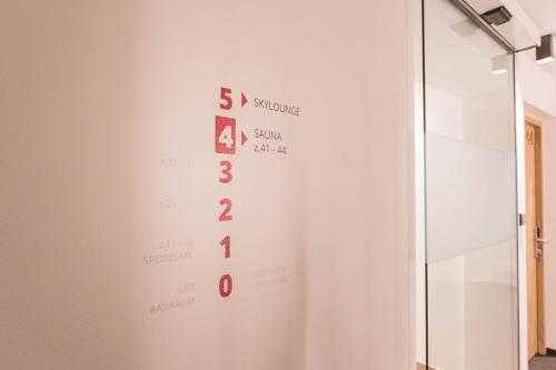 a white wall with a sign on it at Belvenu Boutique Hotel in Glorenza