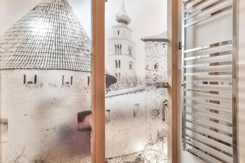 a window with a view of a castle at Belvenu Boutique Hotel in Glorenza