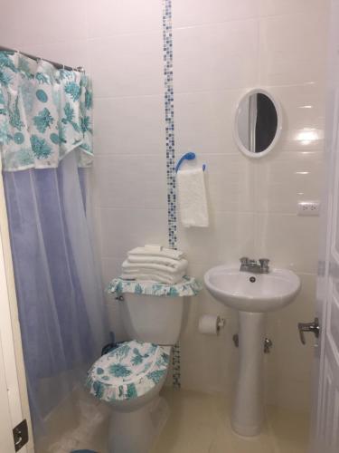 a bathroom with a toilet and a sink at Blue Acuarela in Cabrera