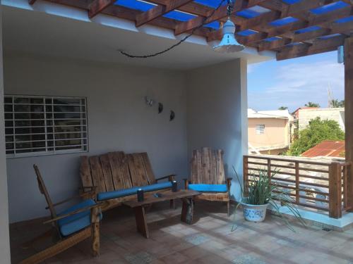 two chairs and a bench on a patio at Blue Acuarela in Cabrera