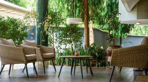 a patio with chairs and a table and plants at Nordic Villa in Abuja