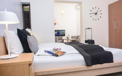 a bedroom with a bed with a clock on the wall at Nordic Villa in Abuja