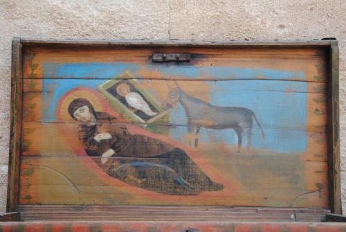 a painting of a woman and a horse on a wall at Kirkit Hotel in Avanos