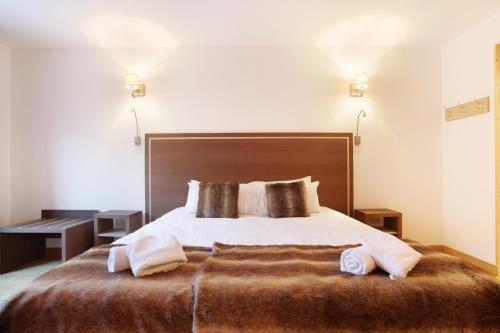Ένα ή περισσότερα κρεβάτια σε δωμάτιο στο Hôtel Odalys Le Chamois