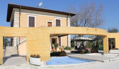 a wooden archway in front of a house at Villa Tivoli in Guidonia