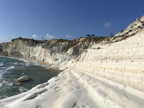 a cliff with snow on it next to the ocean at Alludo Aparthotel b&b in Agrigento
