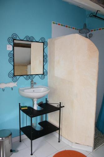a bathroom with a sink and a mirror at La Guichardière in Vay