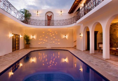 an indoor pool in a house with a staircase at Casa Kimberly Boutique Hotel in Puerto Vallarta