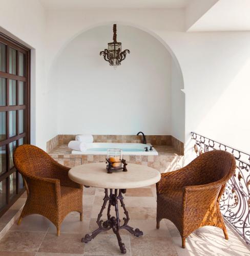 a room with a table and two chairs and a bed at Casa Kimberly Boutique Hotel in Puerto Vallarta