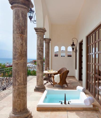 a pool in the middle of a patio with a table at Casa Kimberly Boutique Hotel in Puerto Vallarta