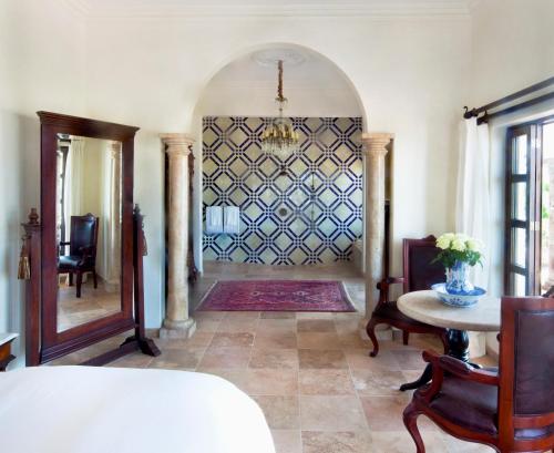 a room with a hallway with a table and a chandelier at Casa Kimberly Boutique Hotel in Puerto Vallarta