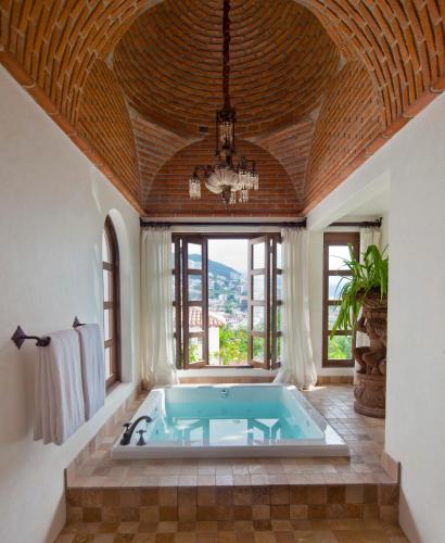 a large bathroom with a large jacuzzi tub at Casa Kimberly Boutique Hotel in Puerto Vallarta