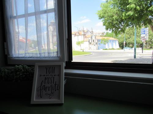 a window with a sign that says you must struggle at Most Art Boutique Hostel in Leiria