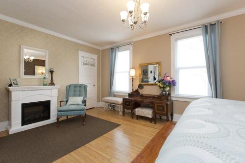 a bedroom with a bed and a desk and a bed and a room at Charles Street Vacation Home in Lethbridge
