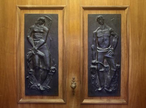 two paintings of a man and a woman on a door at Villa Ottolenghi Wedekind in Acqui Terme