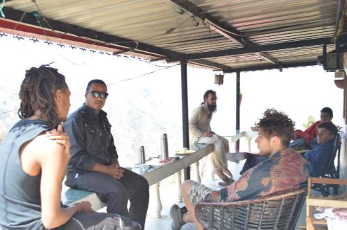 a group of people sitting around in a building at Dhanaulti Camp Homes Retreat in Dhanaulti