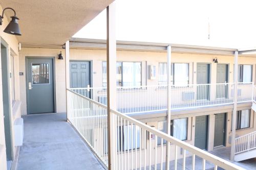 a hallway of an apartment building with a blue door at Highland Country Inn Flagstaff in Flagstaff