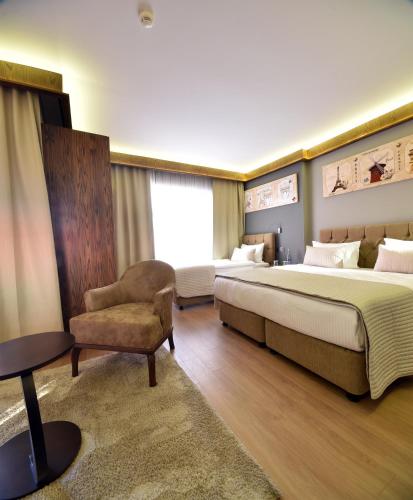 ein Hotelzimmer mit einem Bett und einem Stuhl in der Unterkunft The Elegant Hotel in Istanbul