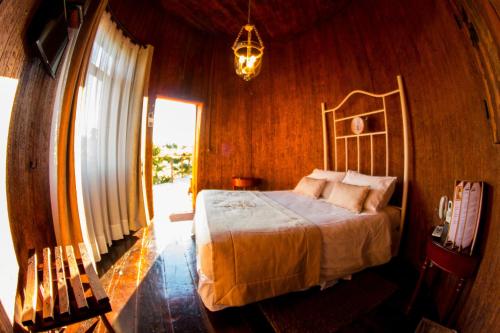 a bedroom with a bed and a mirror at Cava Colchagua Hotel Boutique in Santa Cruz
