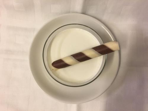 a plate with a chocolate stick on top of it at Hotel El Tabanco in El Bosque