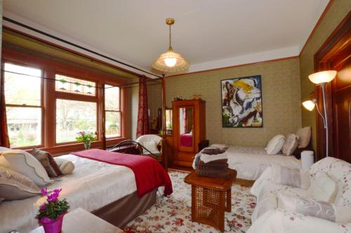 a hotel room with two beds and two chairs at Marketa's Bed and Breakfast in Victoria