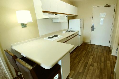 a small kitchen with a counter and a refrigerator at Extended Stay America Suites - Atlanta - Marietta - Powers Ferry Rd in Atlanta