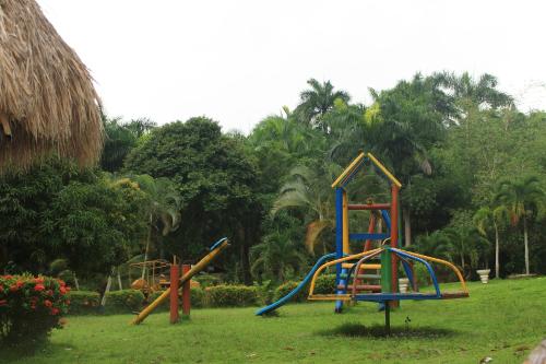 a group of playground equipment in a park at EcoHostal Palmares Del Rio in Guachaca
