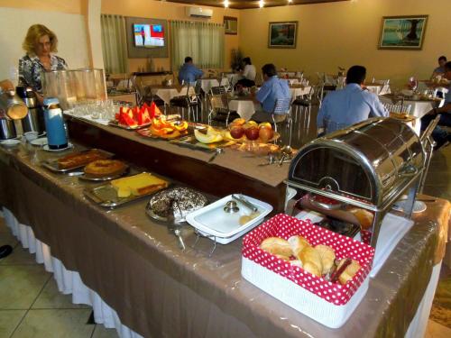 a table with a buffet of food in a restaurant at Augustu's Hotel in Altamira