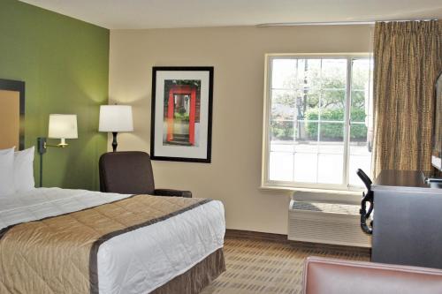 a hotel room with a bed and a window at Extended Stay America Suites - Kansas City - Overland Park - Nall Ave in Overland Park