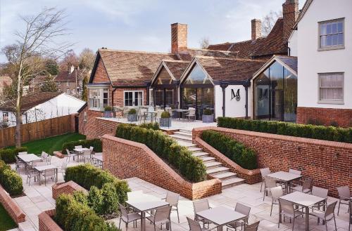 a courtyard with tables and chairs in front of a building at Marquis Suffolk in Ipswich