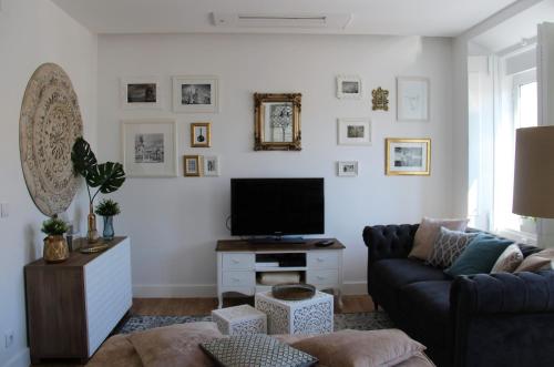 a living room with a couch and a tv at Lisboa 1912 - Alojamento de Charme in Lisbon