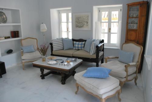 a living room with a couch and chairs and a table at Hydras Chromata in Hydra