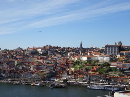 a view of a city with boats in the water at Bom dia Porto in Vila Nova de Gaia
