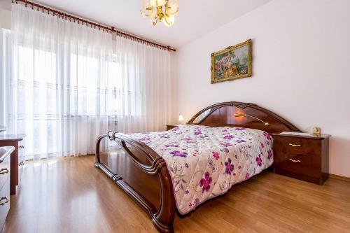 a bedroom with a bed and a dresser and a window at Apartments Orlic in Medulin