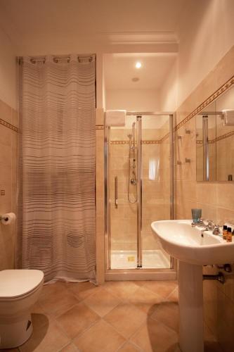 a bathroom with a shower and a sink and a toilet at Albornoz 35 in Rome