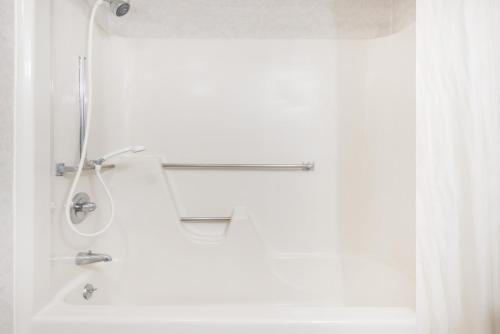 a shower in a bathroom with a shower curtain at Super 8 by Wyndham State College in State College