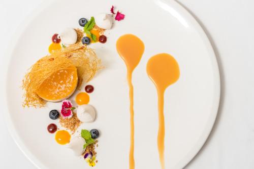 a white plate with food on it with spoons at Distinction Hamilton Hotel & Conference Centre in Hamilton
